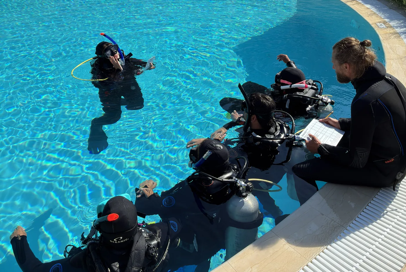 Divers preparing for skills practice at the poolside