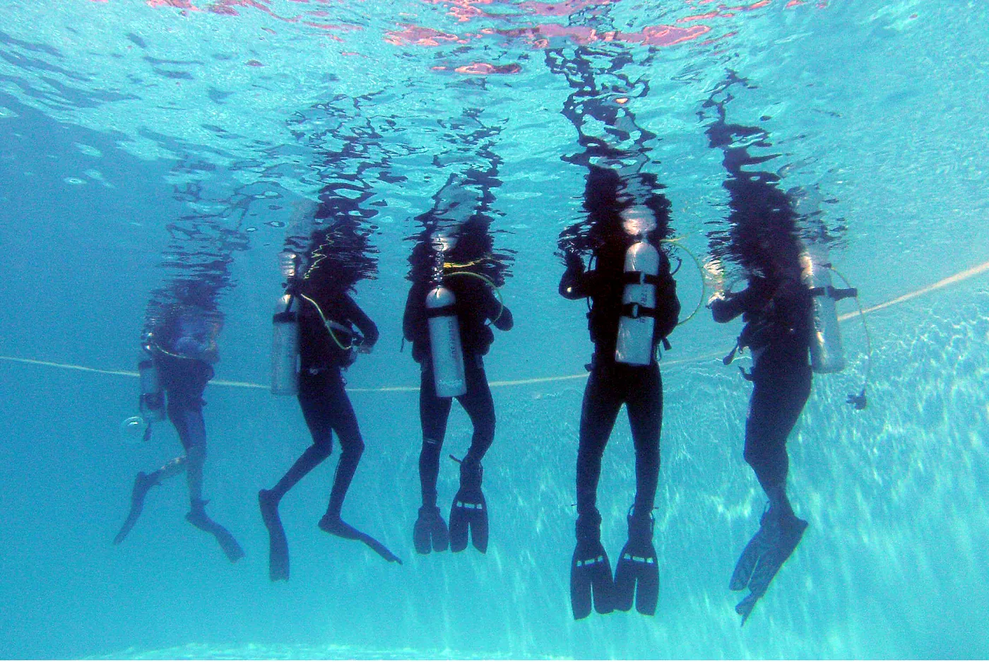 IDC candidates practising together underwater in the pool