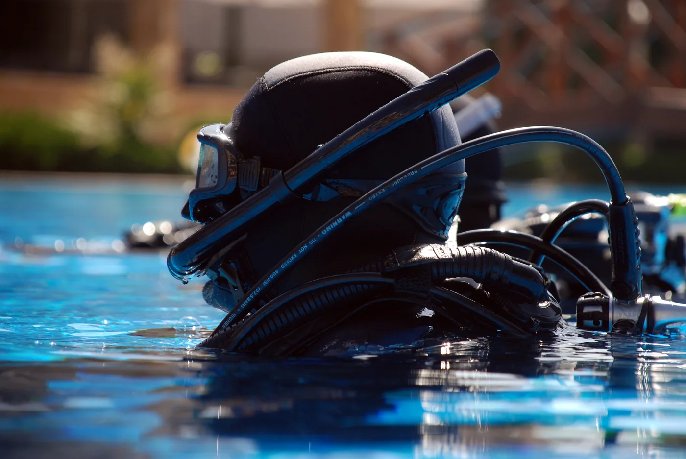 A diver wearing scuba equipment during pool training