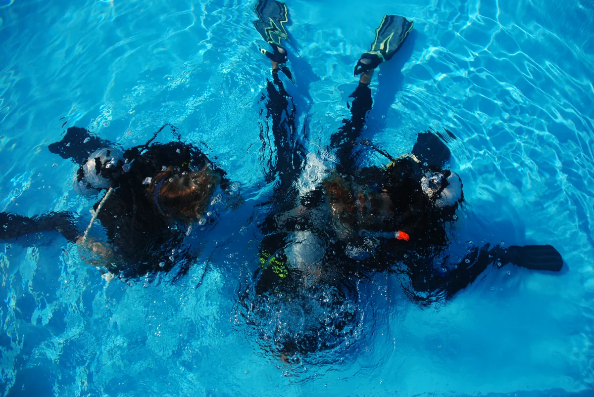 Divers practising snorkelling skills in the pool