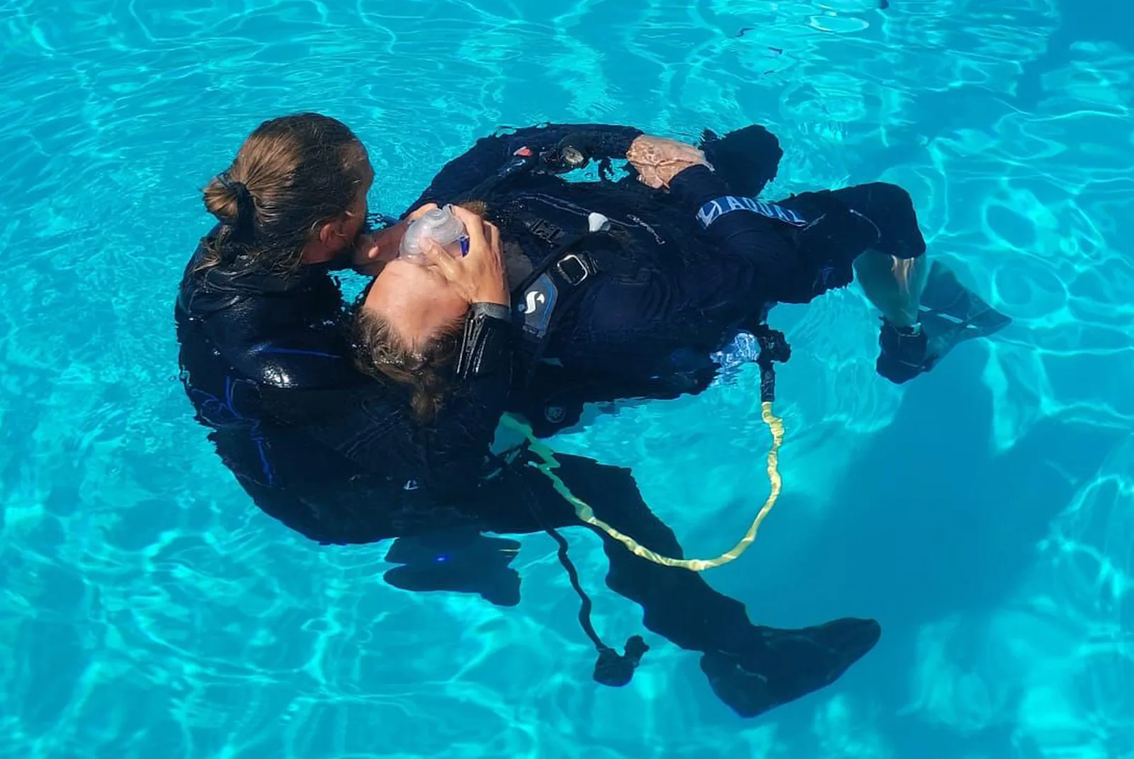 Divers practising a rescue exercise in the pool