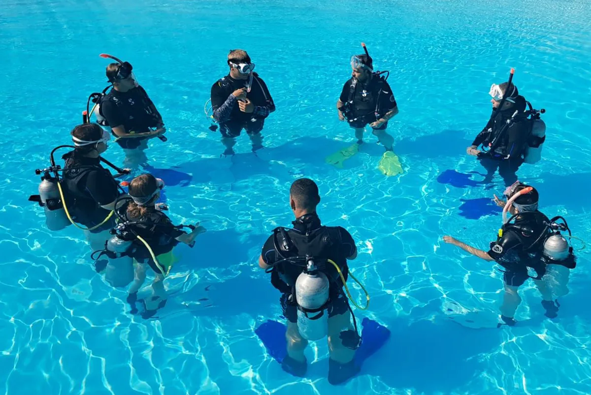 Divers gathered for a pool training briefing